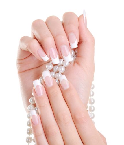 Beautiful elegant female hand with beauty french manicure over white background